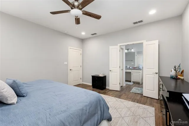 a bedroom with a bed and a view of kitchen