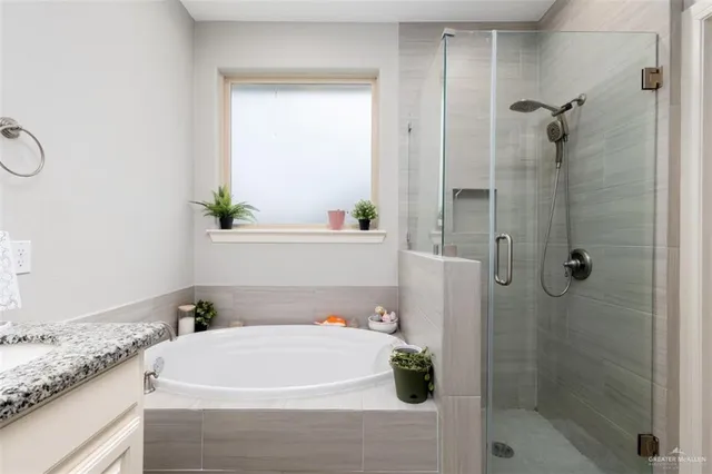 a bathroom with a bathtub and shower