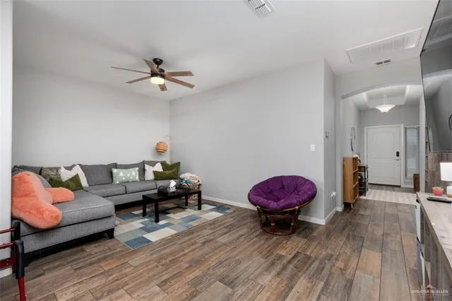 a living room with furniture and wooden floor