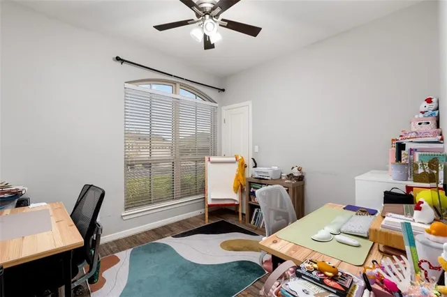 a view of a workspace with furniture and a window
