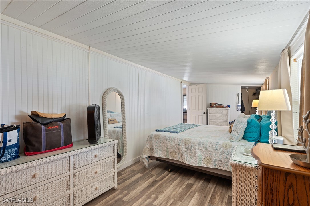 20550 Basin Drive Estero, FL 33928 - Photo 21 of 34 a bedroom with a bed and dresser with mirror