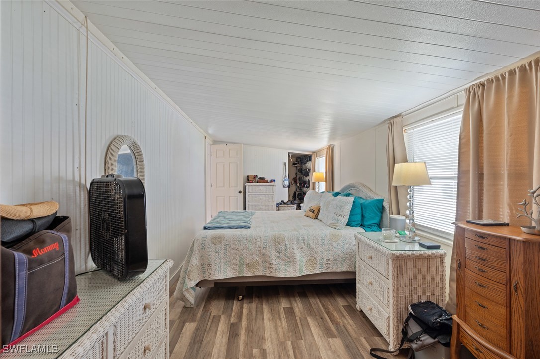 20550 Basin Drive Estero, FL 33928 - Photo 22 of 34 a bedroom with a bed and wooden floor