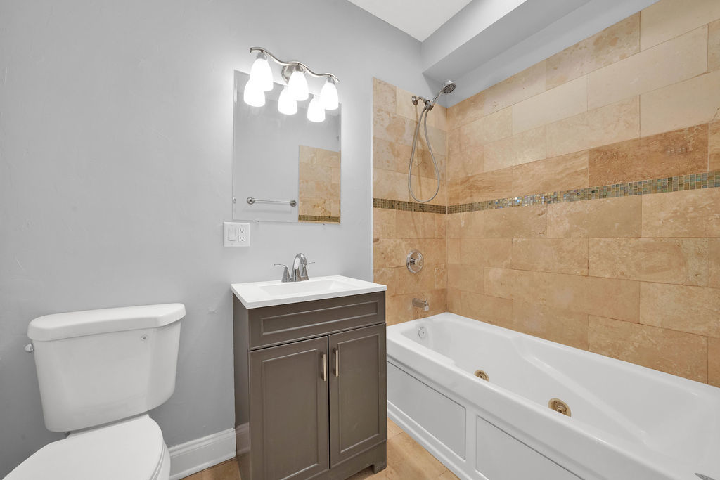 2256 West Arthur Avenue, Unit 2 Chicago, IL 60645 - Photo 16 of 22 a bathroom with a sink a toilet and shower