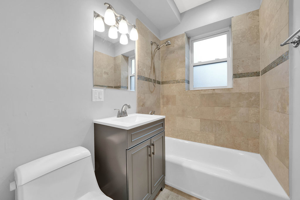 2256 West Arthur Avenue, Unit 2 Chicago, IL 60645 - Photo 19 of 22 a bathroom with a sink a toilet and bathtub