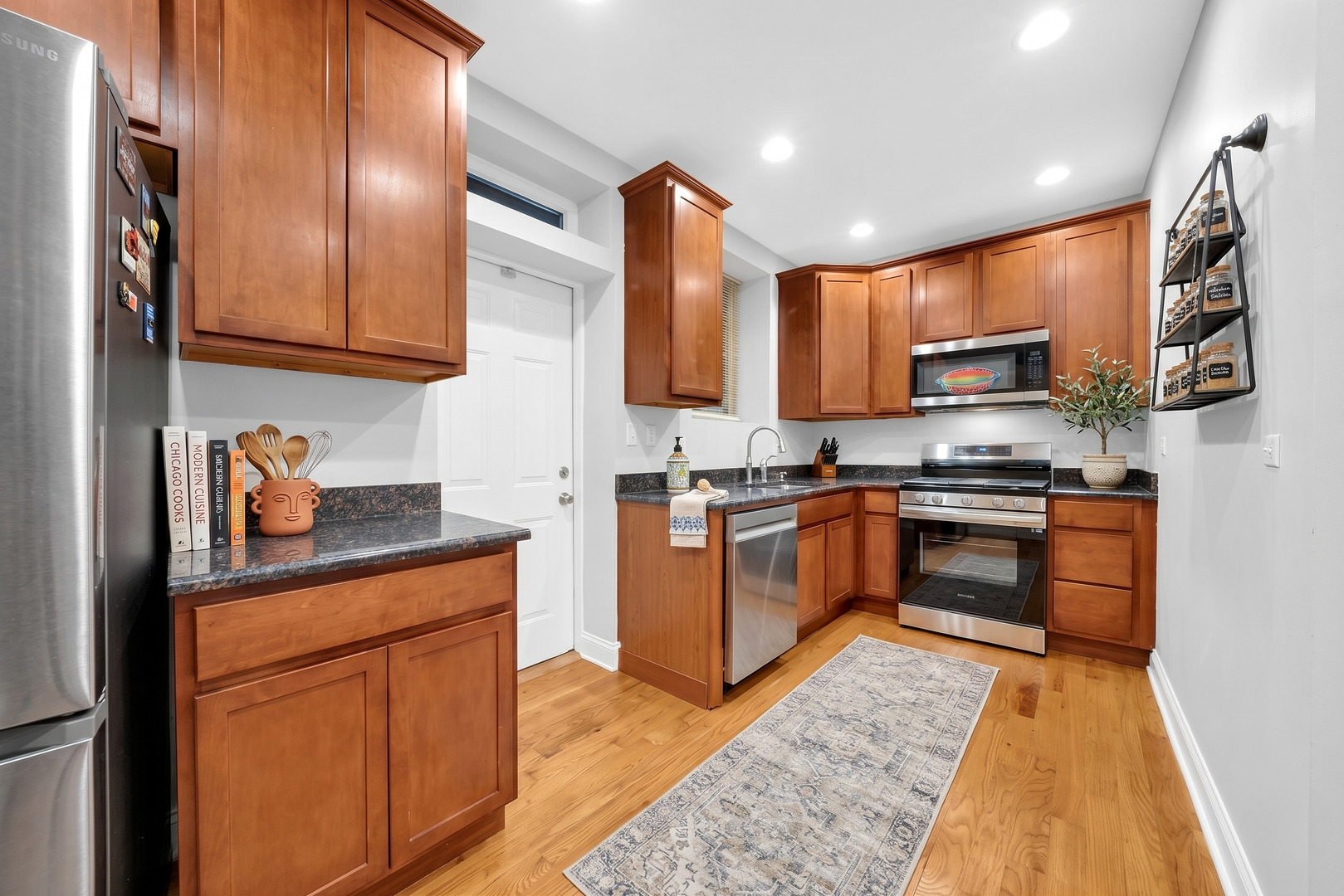 2256 West Arthur Avenue, Unit 2 Chicago, IL 60645 - Photo 2 of 22 a kitchen with stainless steel appliances granite countertop a stove a sink and a refrigerator