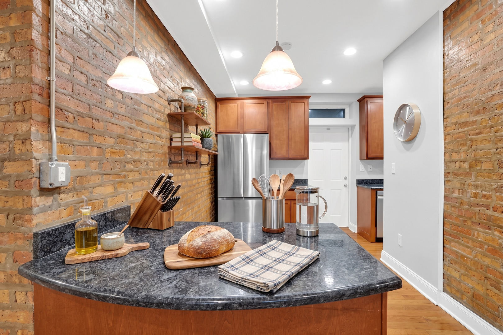 2256 West Arthur Avenue, Unit 2 Chicago, IL 60645 - Photo 4 of 22 a kitchen with stainless steel appliances granite countertop a sink a stove and a wooden floors