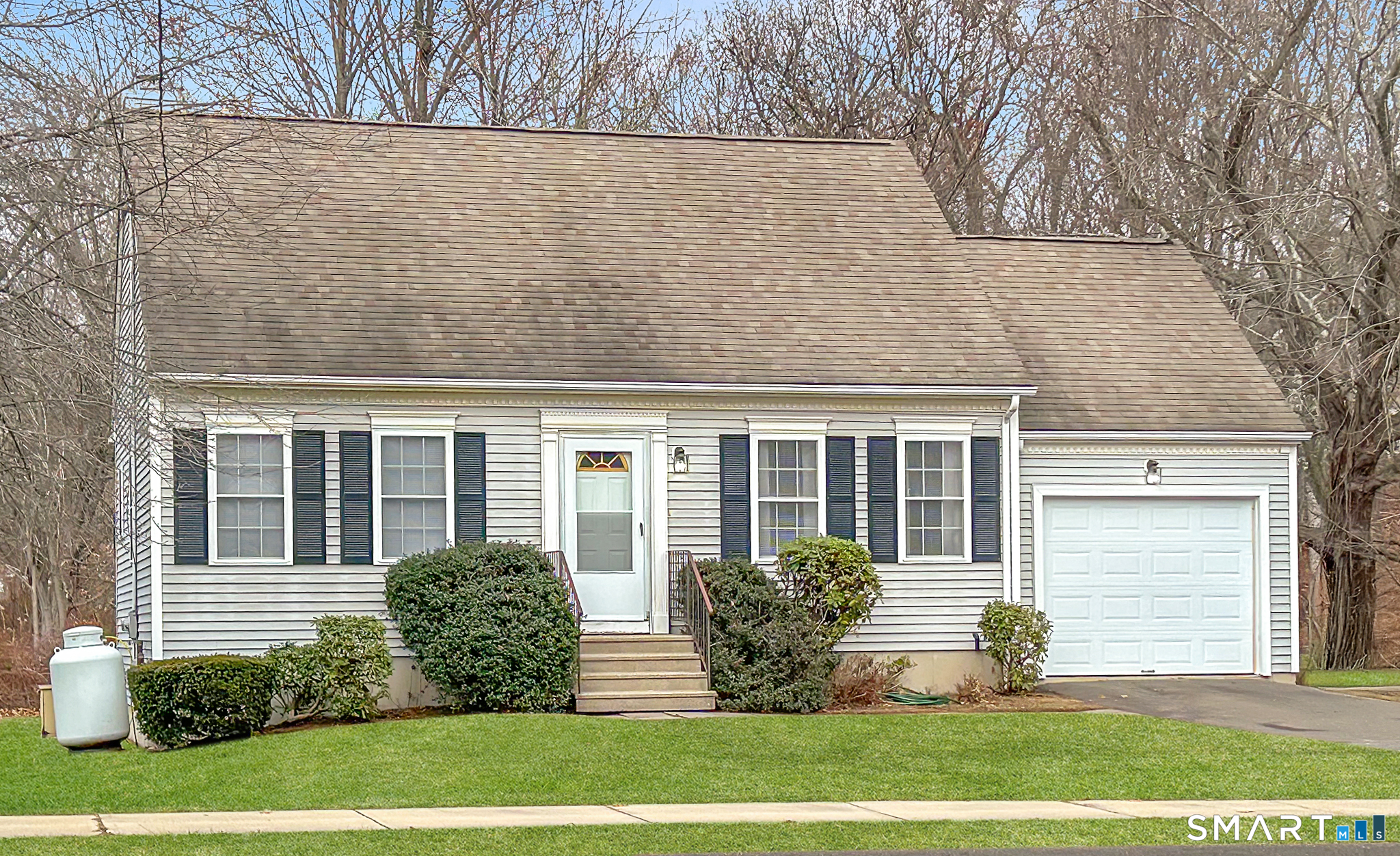 a view of house with yard and outdoor seating