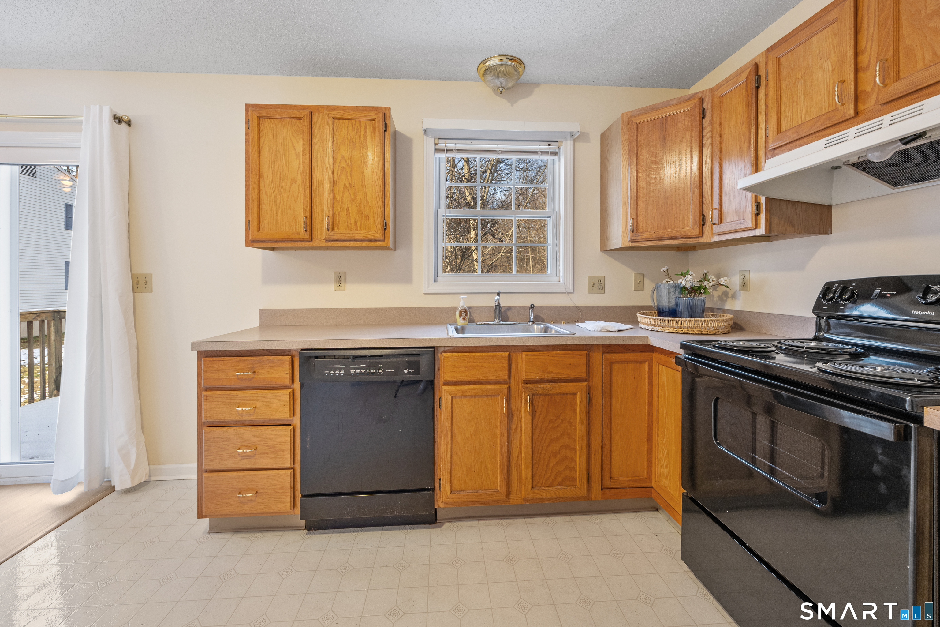 454 Maple Avenue Bristol, CT 06010 - Photo 11 of 27 a kitchen with stainless steel appliances granite countertop a stove and cabinets