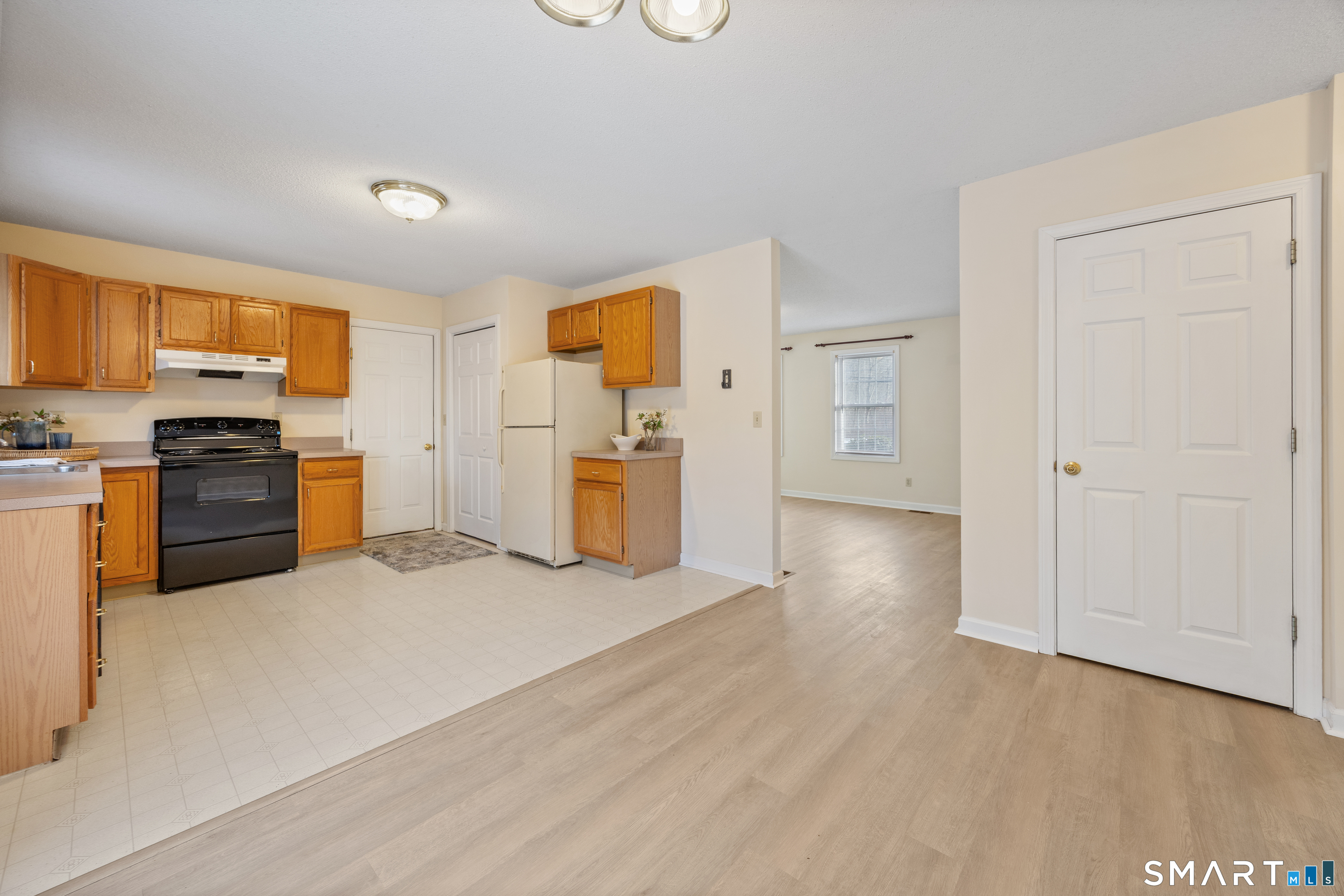 454 Maple Avenue Bristol, CT 06010 - Photo 12 of 27 a view of a kitchen with a stove cabinets and wooden floor