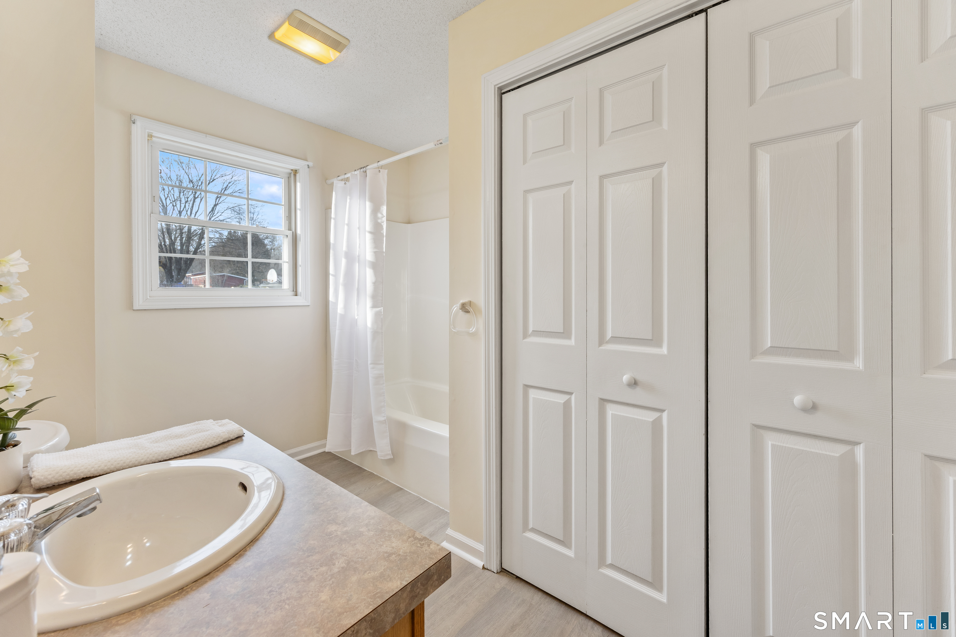 454 Maple Avenue Bristol, CT 06010 - Photo 17 of 27 a bathroom with a granite countertop sink and a mirror