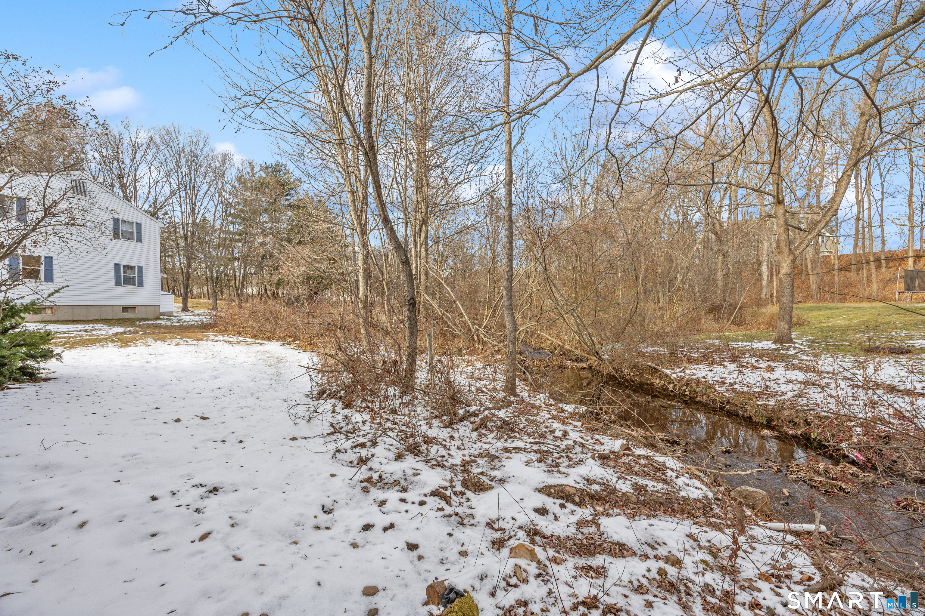 454 Maple Avenue Bristol, CT 06010 - Photo 24 of 27 a view of a yard covered with snow