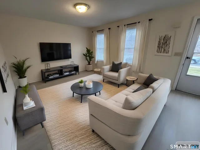 a living room with furniture and a flat screen tv