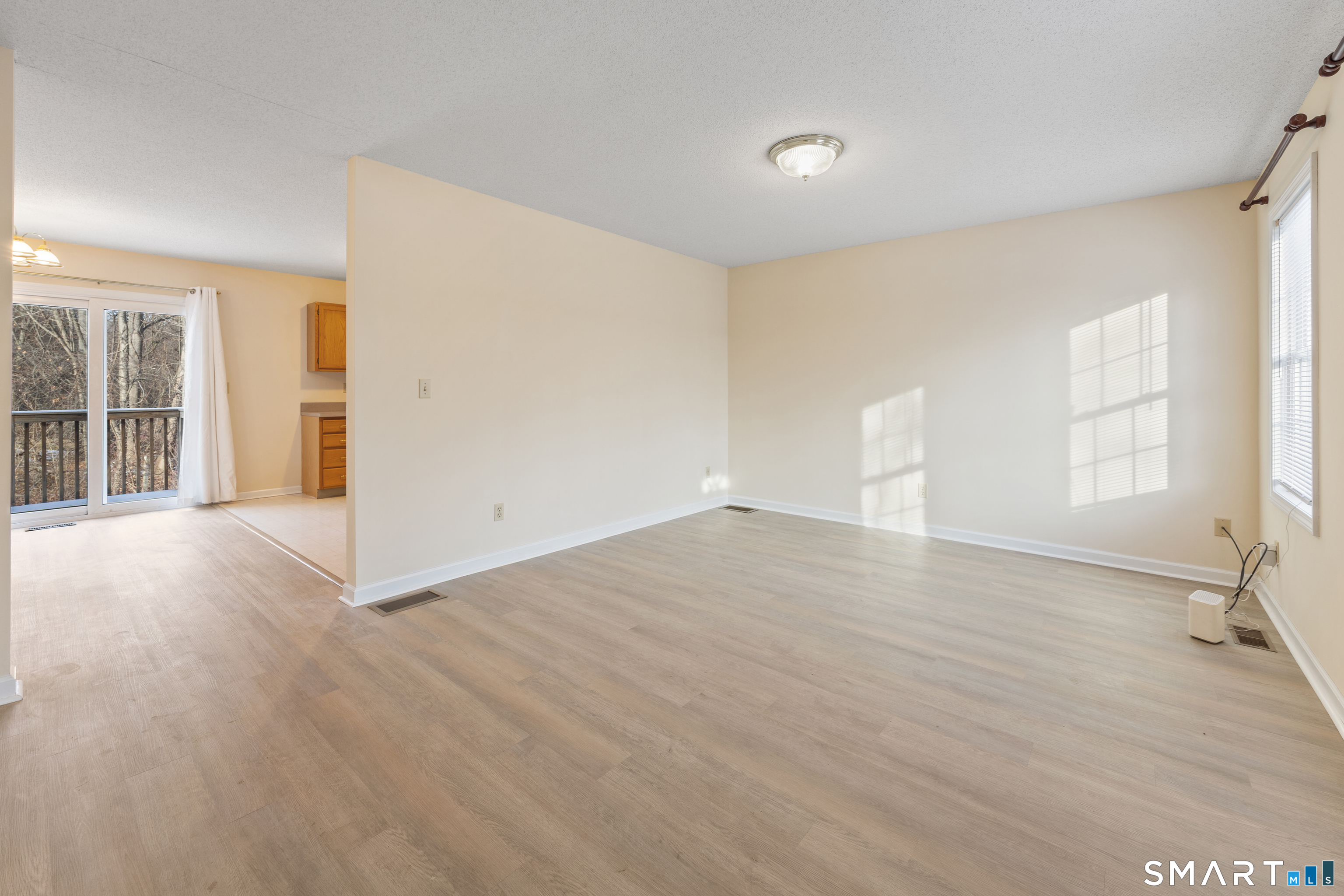 454 Maple Avenue Bristol, CT 06010 - Photo 6 of 27 an empty room with wooden floor and windows