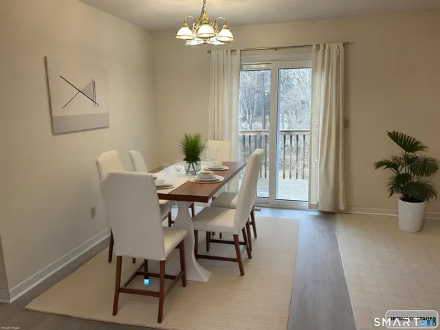 a view of a dining room with furniture window and outside view