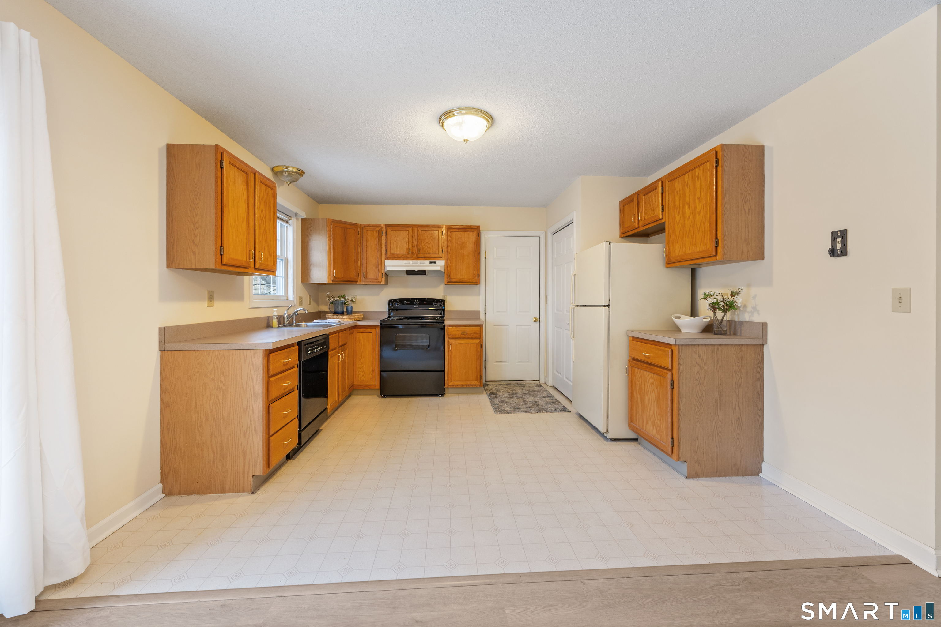 454 Maple Avenue Bristol, CT 06010 - Photo 10 of 27 a kitchen with a sink a stove top oven and stainless steel appliances