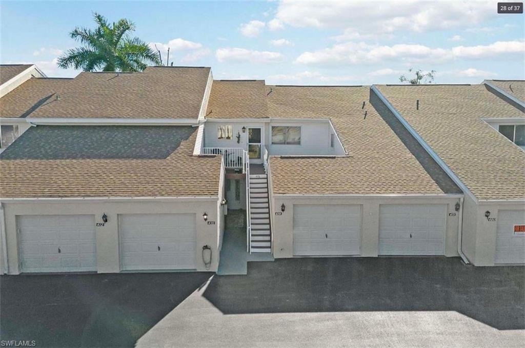 476 Bristle Cone Lane, Unit 39 Naples, FL 34113 - Photo 11 of 16 View of front of home with a balcony and a shingled roof