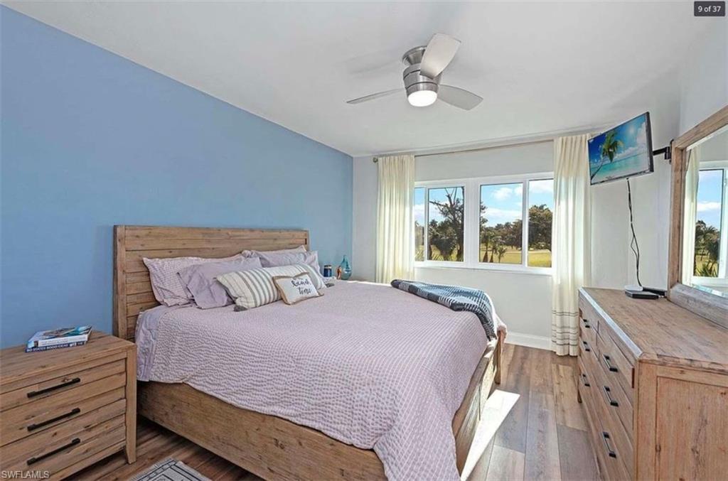 476 Bristle Cone Lane, Unit 39 Naples, FL 34113 - Photo 8 of 16 Bedroom with wood-type flooring and ceiling fan