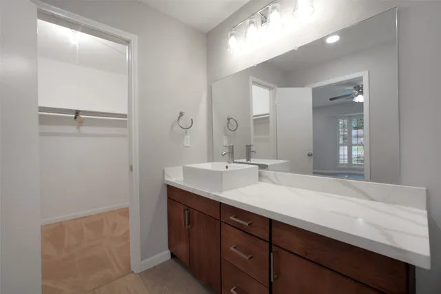 a bathroom with a sink vanity and a mirror