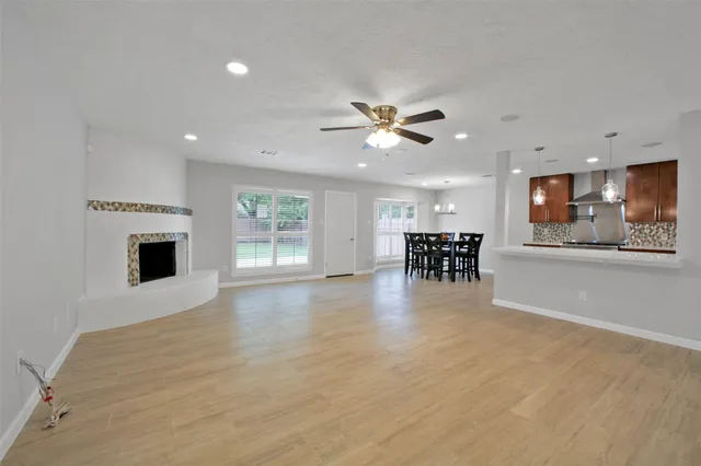 a kitchen with a sink and a stove next to a window