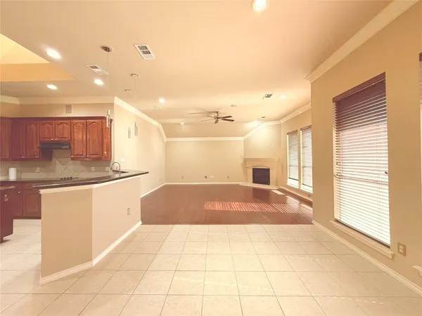 a spacious bathroom with a granite countertop sink a toilet a mirror and a shower