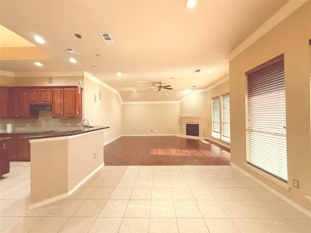 a spacious bathroom with a granite countertop sink a toilet a mirror and a shower