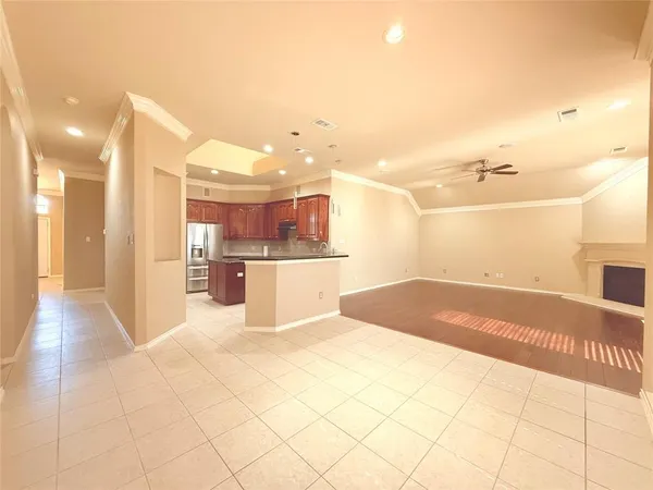 a view of a kitchen with kitchen island granite countertop a refrigerator and a sink