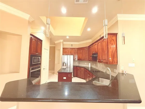 a kitchen with stainless steel appliances granite countertop a sink counter space and a window