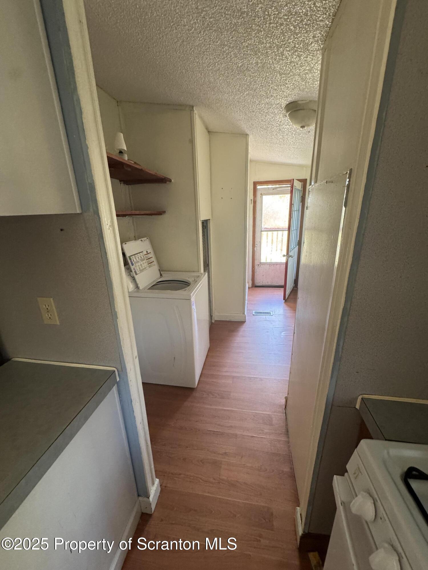 1125 Hall Road New Milford, PA 18834 - Photo 10 of 18 a view of a hallway with furniture and wooden floor