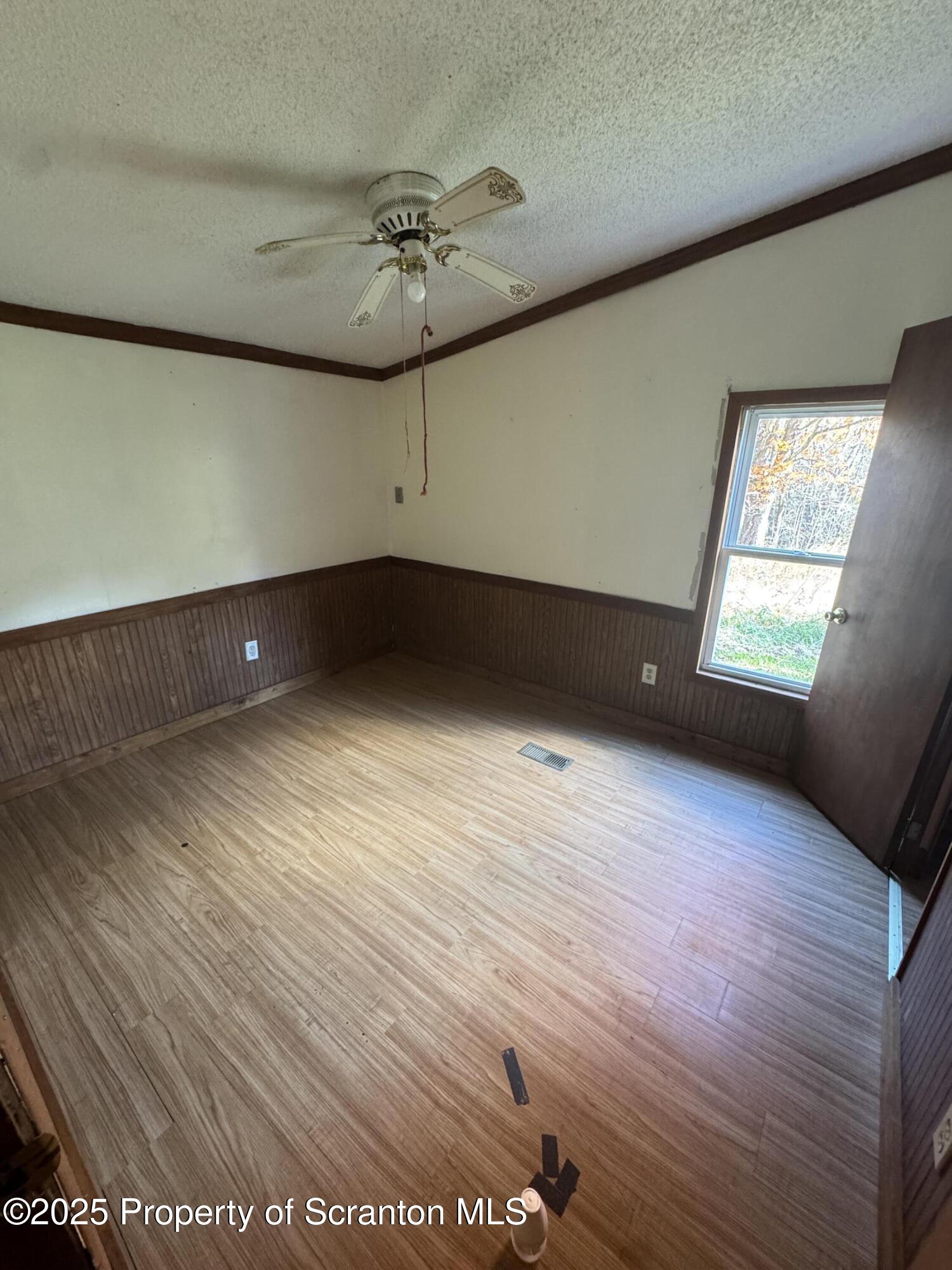 1125 Hall Road New Milford, PA 18834 - Photo 16 of 18 an empty room with wooden floor and windows