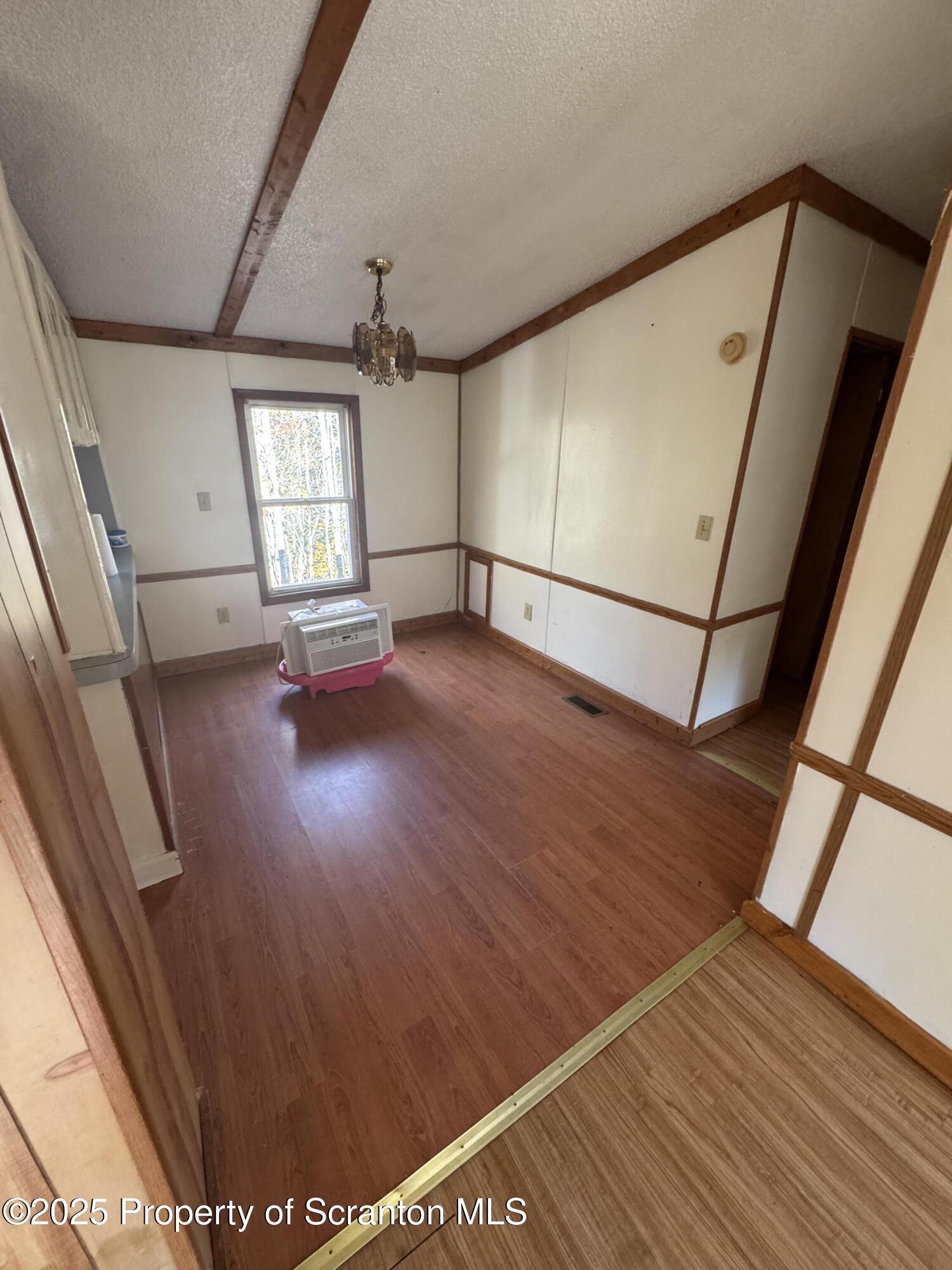 1125 Hall Road New Milford, PA 18834 - Photo 7 of 18 a view of empty room with wooden floor and fan