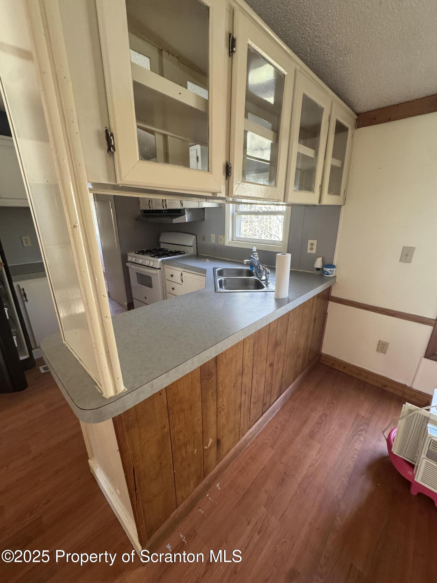 1125 Hall Road New Milford, PA 18834 - Photo 8 of 18 a view of a kitchen with stainless steel appliances wooden floor and cabinets