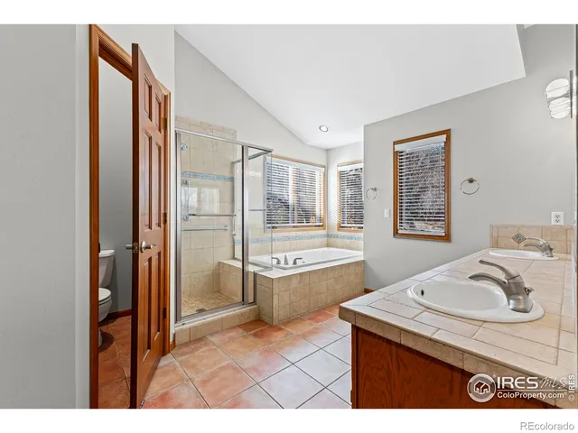 a bathroom with a granite countertop sink mirror vanity and bathtub