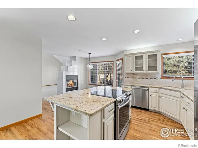 a kitchen that has a sink and a stove in it