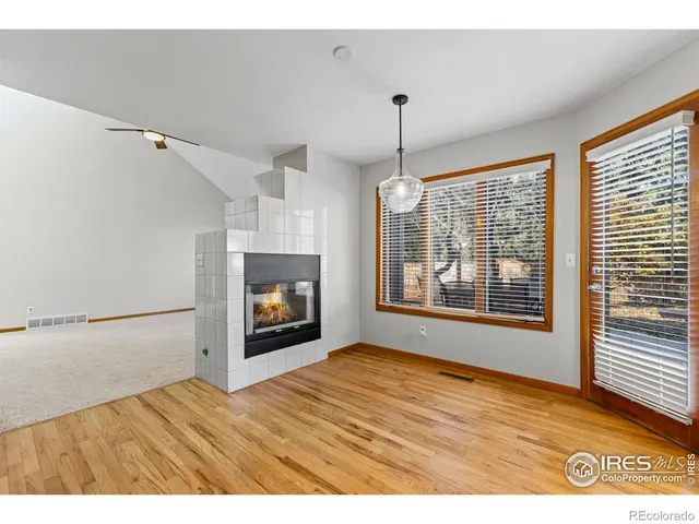 a view of an empty room with a window and fireplace