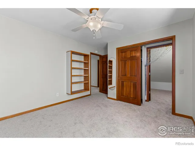 a view of an empty room with a ceiling fan