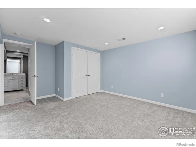 a bathroom with a granite countertop sink a toilet and a mirror