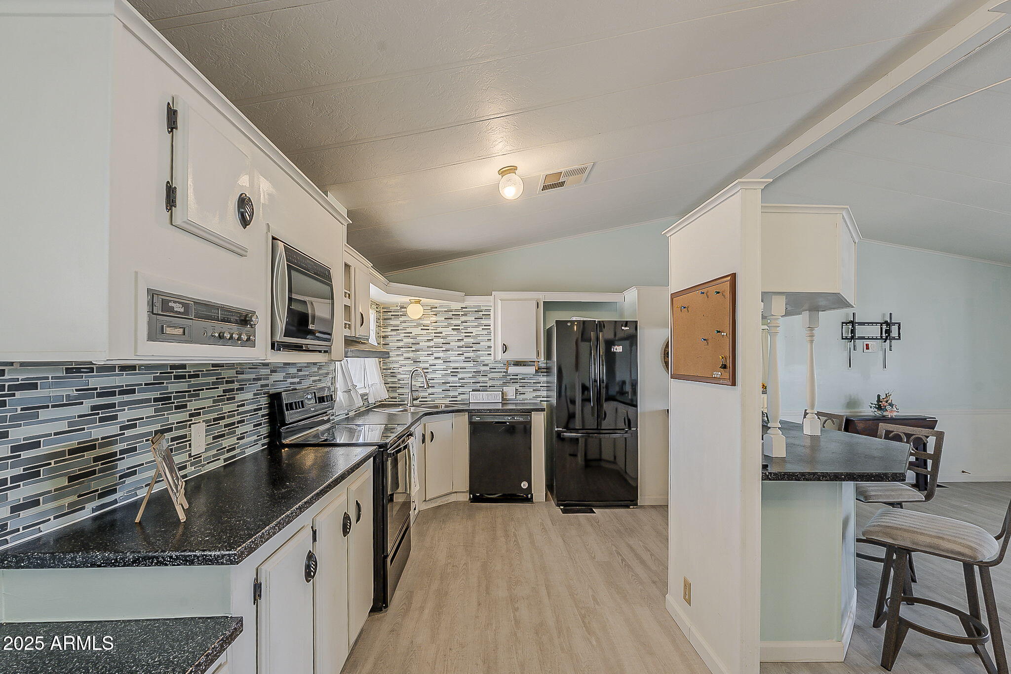 834 South Meridian Road, Unit 118 Apache Junction, AZ 85120 - Photo 20 of 50 a kitchen with stainless steel appliances granite countertop a sink stove and refrigerator