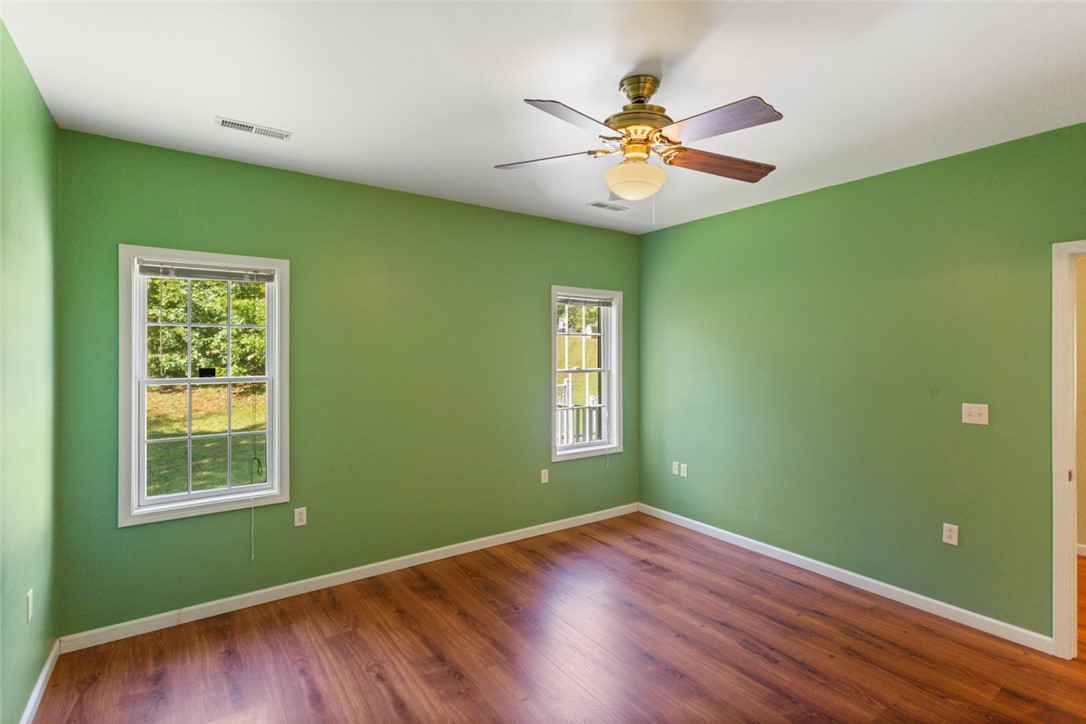 621 Burns Mill Road West Union, SC 29696 - Photo 11 of 45 Wood flooring and ample natural light define this cozy bedroom space.