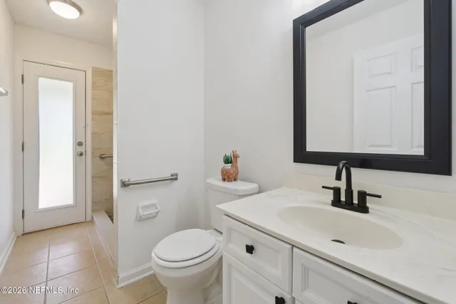 a bathroom with a sink toilet and mirror