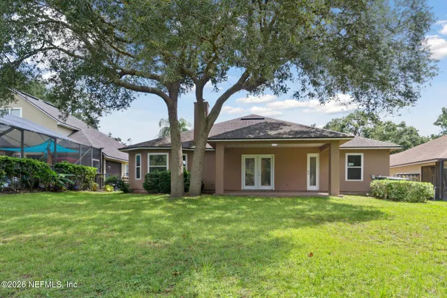 a front view of house with yard and green space