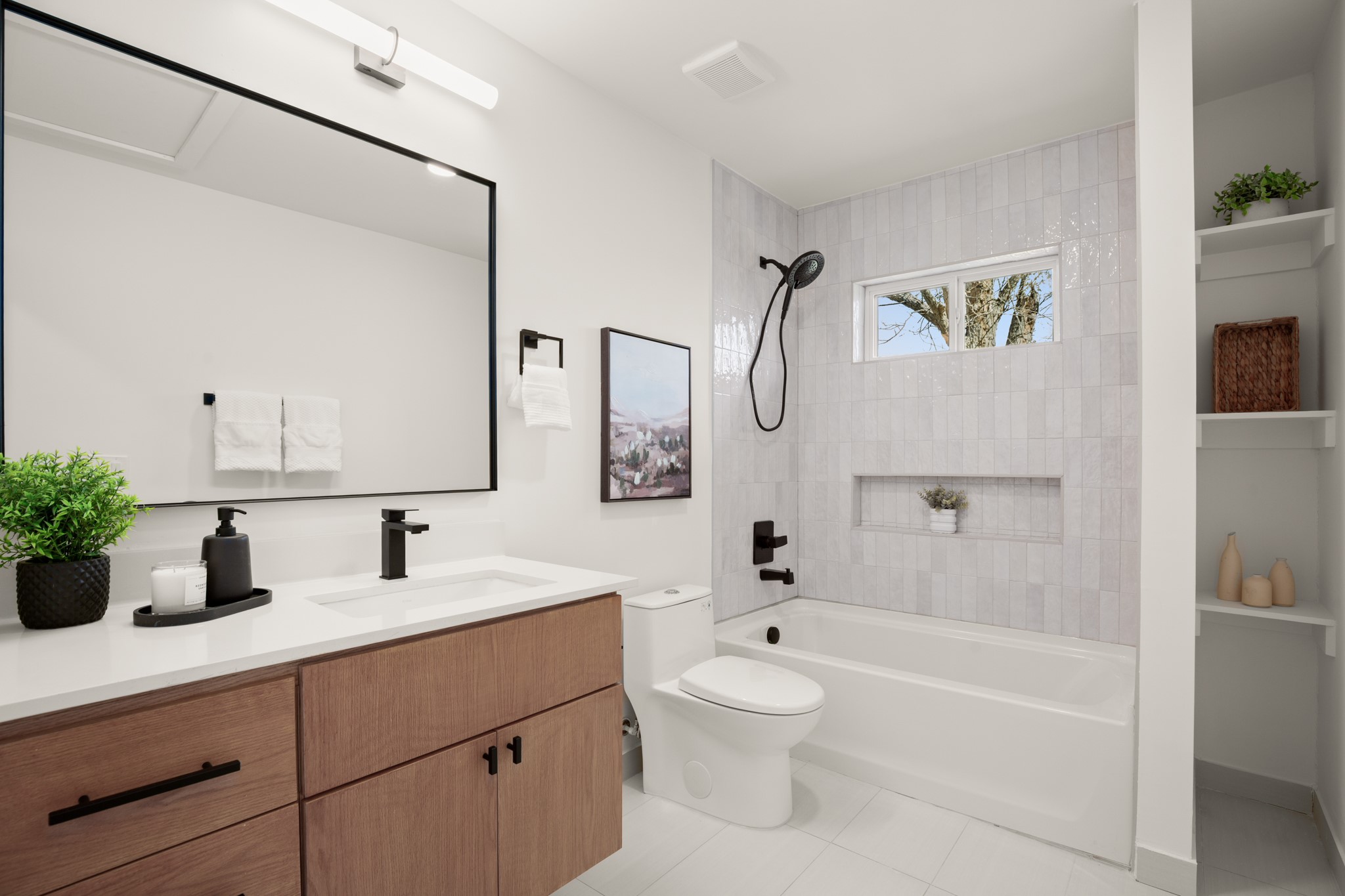 3308 Touchstone Street Austin, TX 78723 - Photo 15 of 38 a bathroom with a sink a mirror a bathtub and a toilet