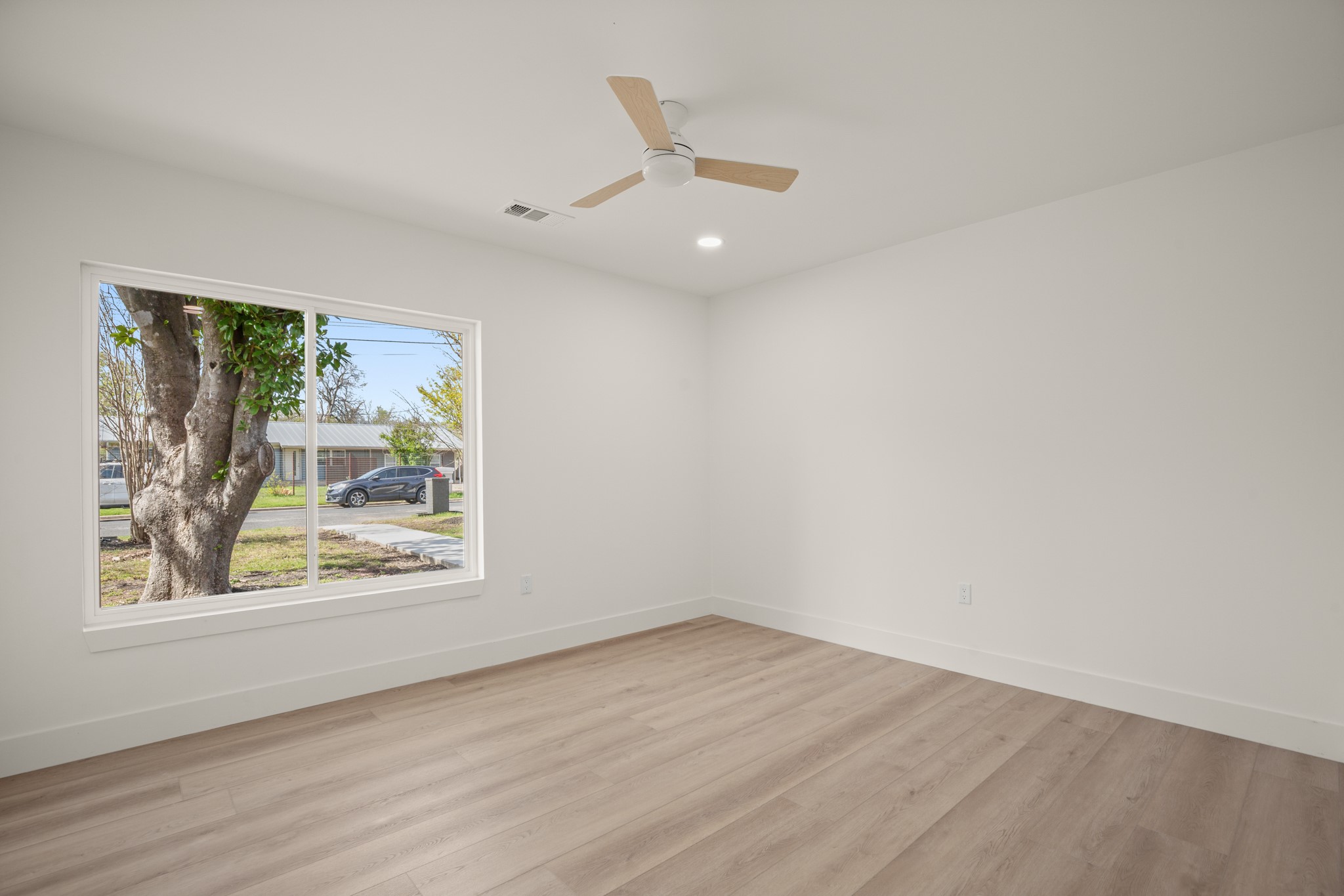 3308 Touchstone Street Austin, TX 78723 - Photo 17 of 38 a view of an empty room with wooden floor and a window