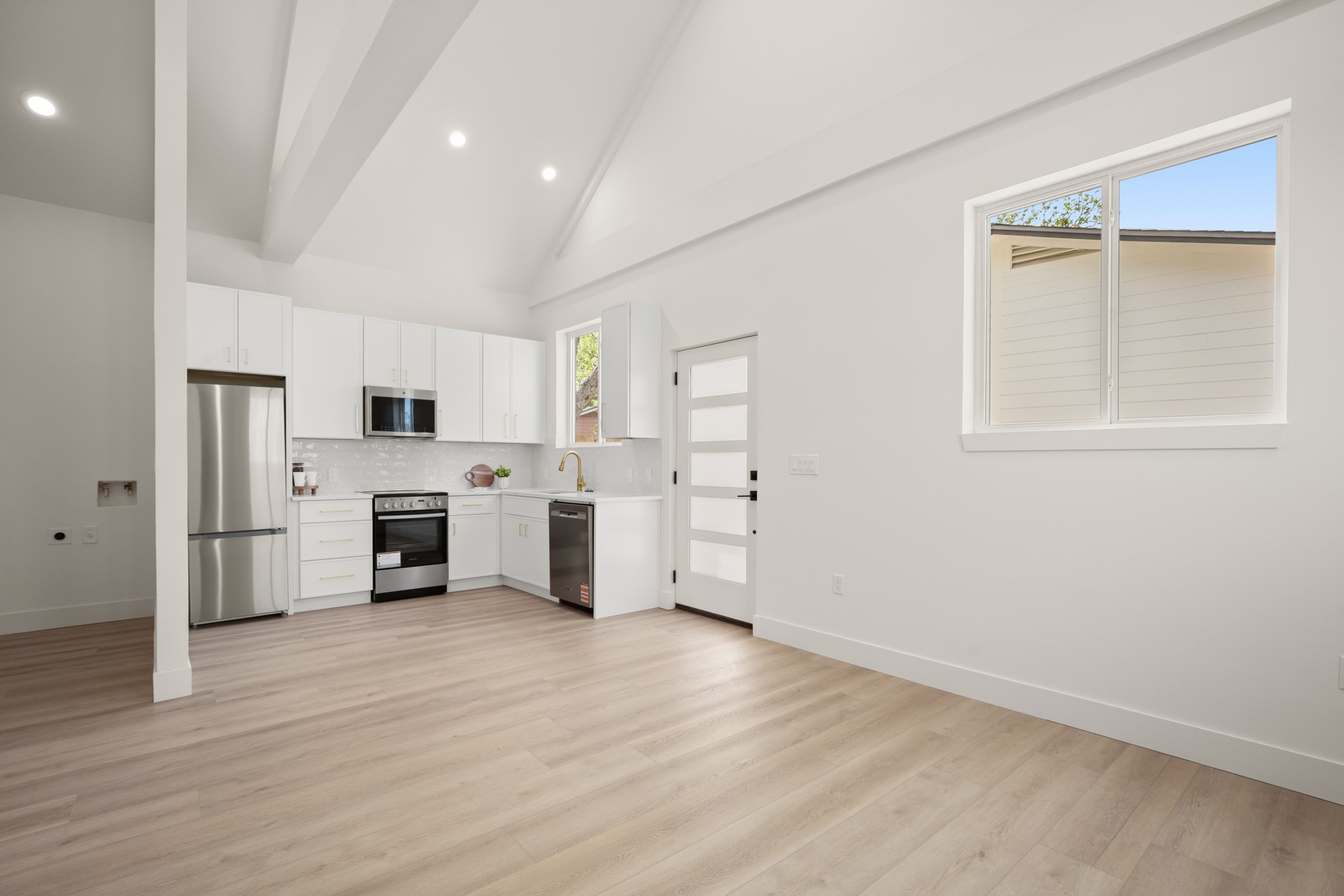 3308 Touchstone Street Austin, TX 78723 - Photo 25 of 38 a view of a kitchen with white cabinets and wooden floor