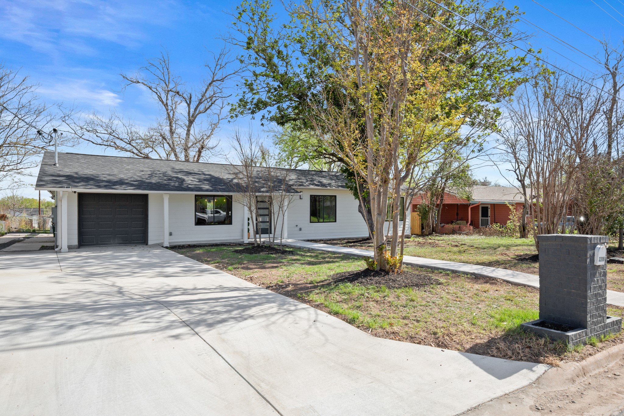 3308 Touchstone Street Austin, TX 78723 - Photo 38 of 38 Ranch-style home featuring concrete driveway, an attached garage, and a front lawn