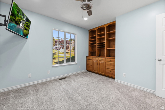 4117 North Wolf Ridge Circle Eden, UT 84310 - Photo 17 of 63 Built-in wood cabinetry with shelving and drawers, light blue walls, and grey carpeted flooring
