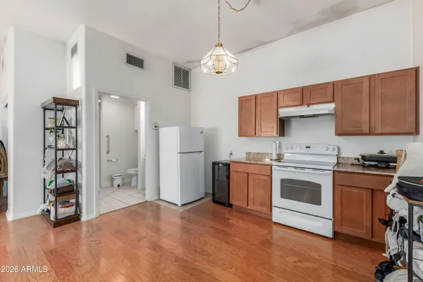a kitchen with stainless steel appliances granite countertop a stove and a refrigerator