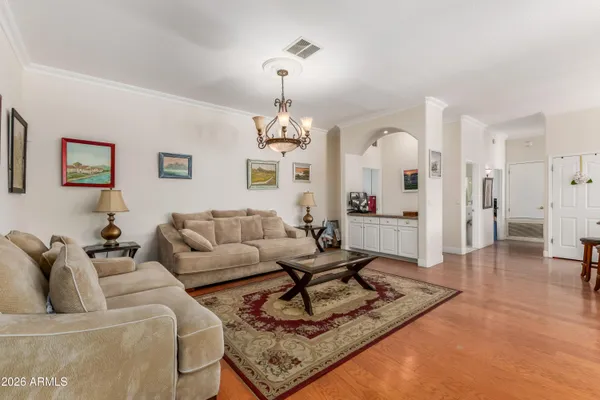 a living room with furniture a rug and a chandelier