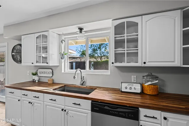 a kitchen with stainless steel appliances granite countertop a sink and cabinets