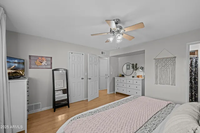 a bedroom with a bed and a chandelier