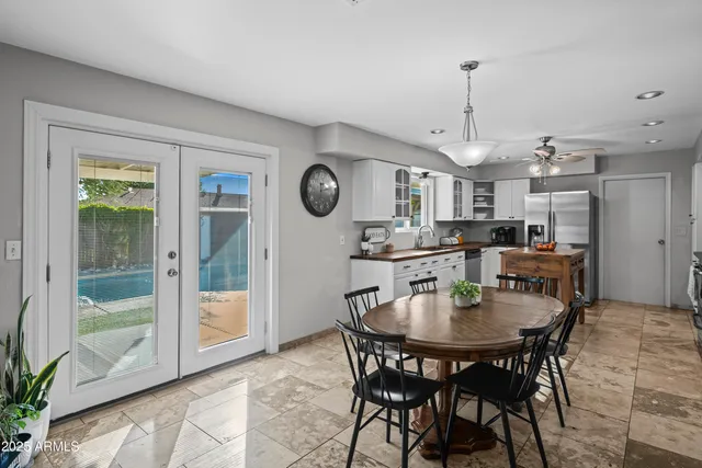 a kitchen with a dining table and chairs